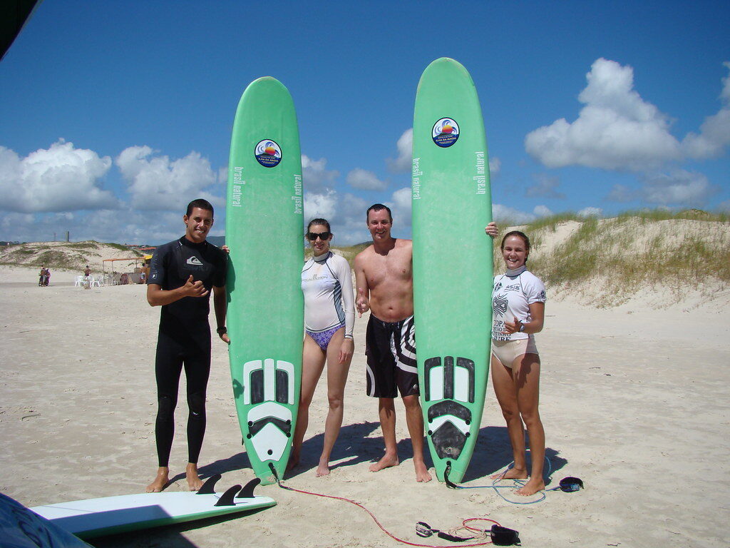 A surf lesson in progress — instructor and learner working one-on-one in the whitewater