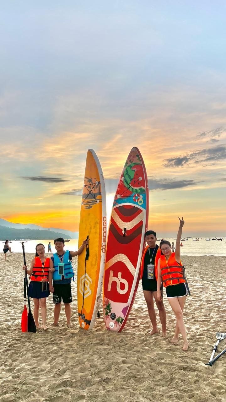 Smiling group with boards and life jackets